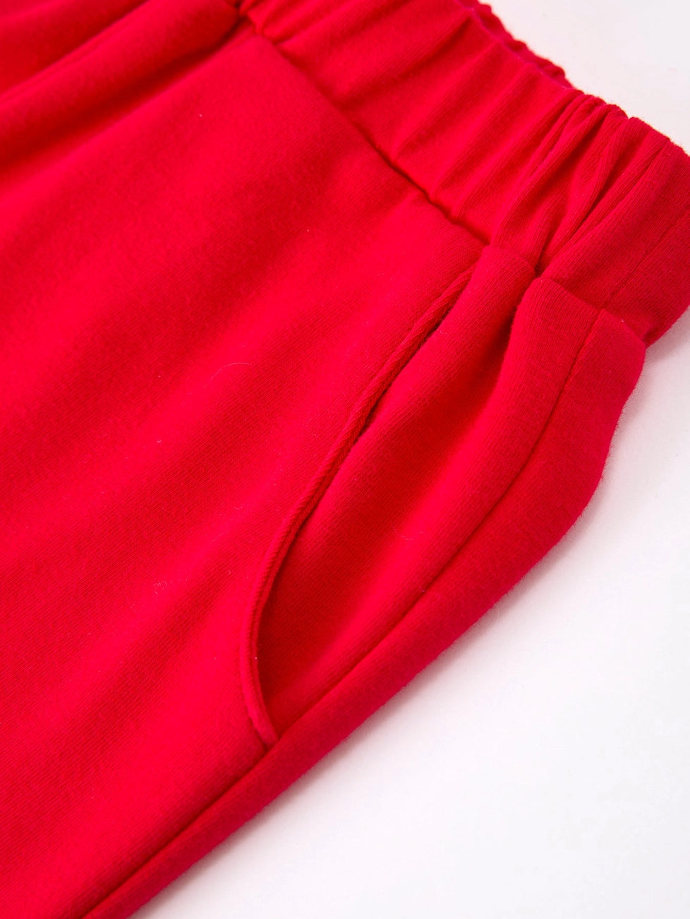 Close-up of red shorts with an elastic waistband on a white background
