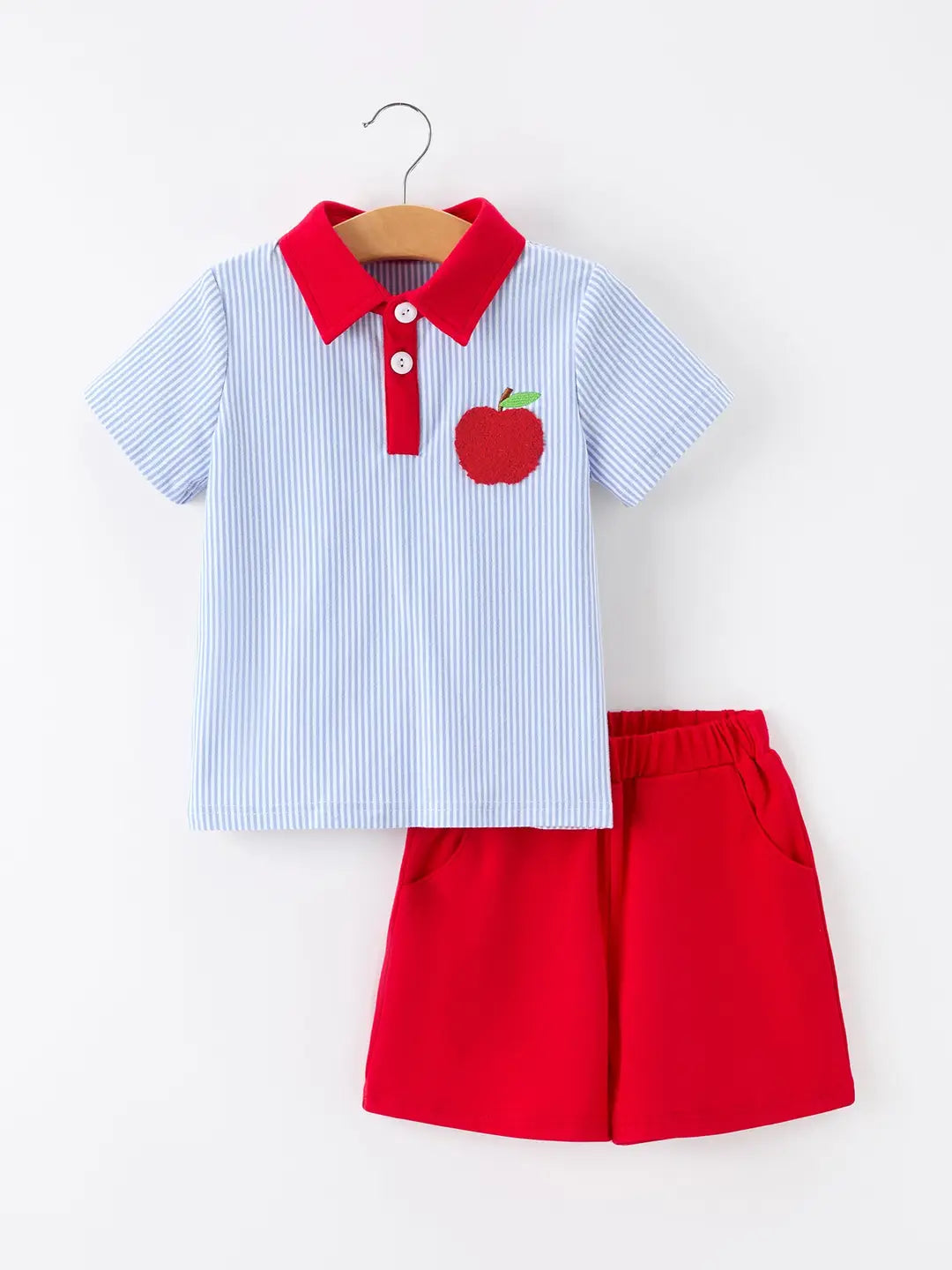 Children's outfit with a striped polo and red shorts on a white background