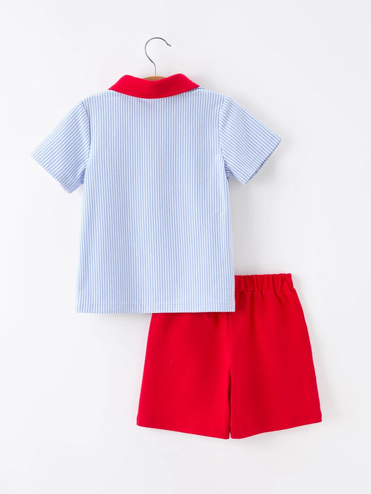 Children's outfit with blue striped shirt and red shorts on a white background